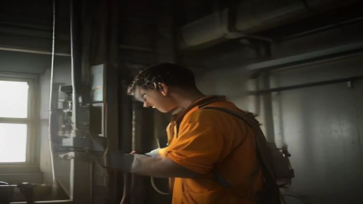 A technician connecting a network cable to a mining machine, hands and ports in sharp focus
